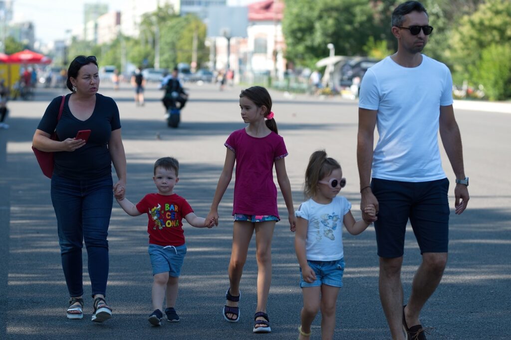 Family walking together in a sunny park